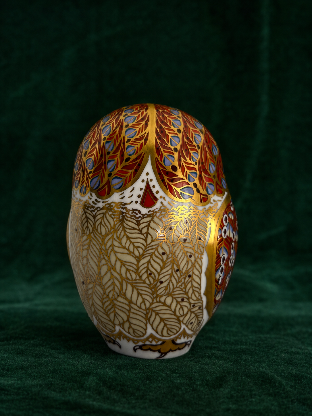 Royal Crown Derby Barn Owl paperweight back view on deep green velvet