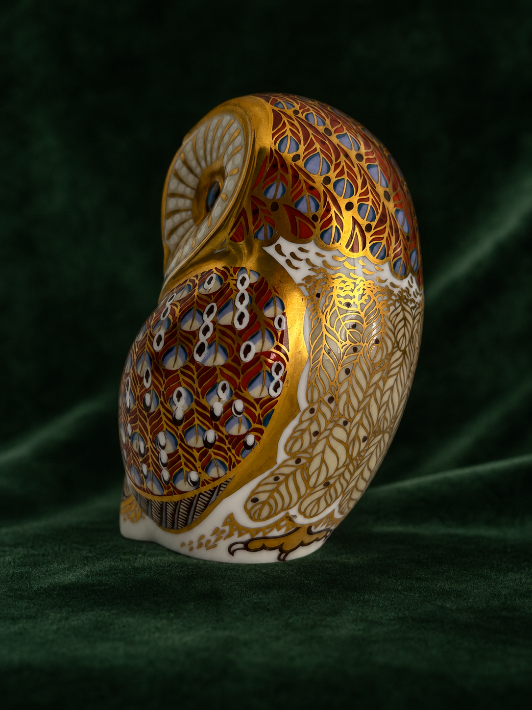 Royal Crown Derby Barn Owl paperweight side view on deep green velvet