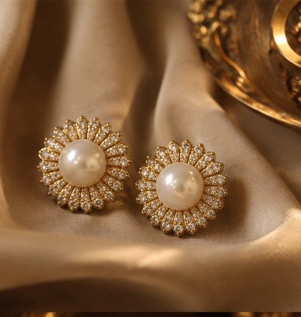 Pearl zircon floral stud earrings on champagne fabric