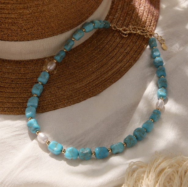 Turquoise-color bead and pearl necklace detail