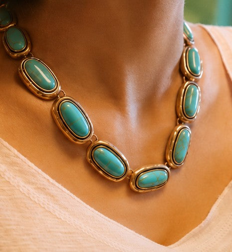 Turquoise silver-tone statement necklace worn by model